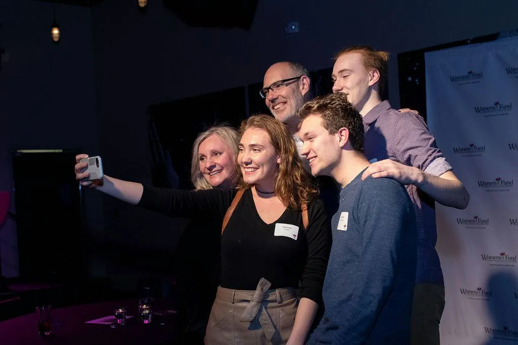 Diverse group of men and women taking a selfie at the Backstage with the Women's Fund event